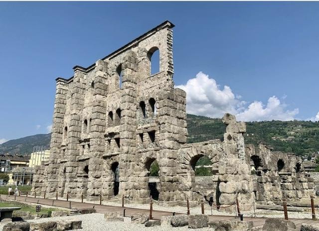 Roman Theatre ruins with mountain backdrop