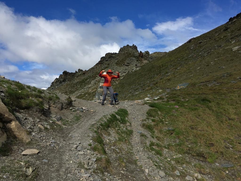 Hiker in red jacket on the mountain trail